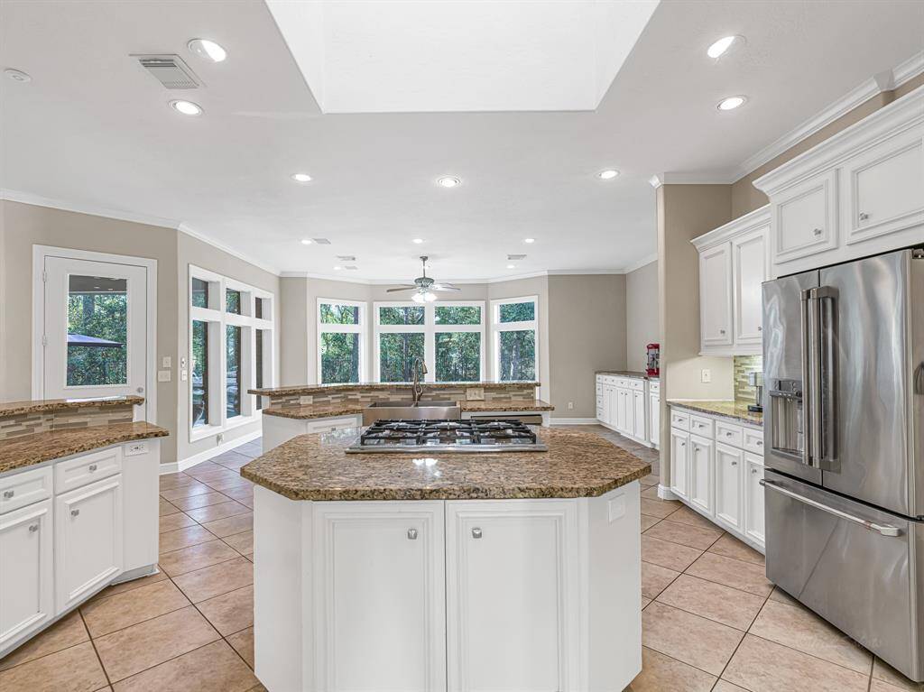 Kitchen features granite countertops, decorative back splash and gas cooktop