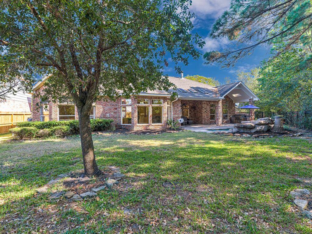 Numerous shade trees surround the back yard