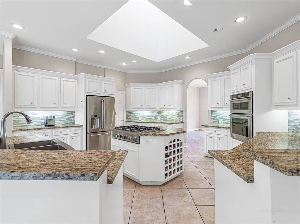 Open island kitchen with built-in wine rack in the island
