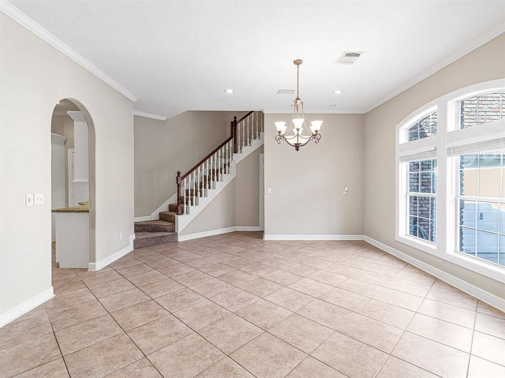 Features crown molding and tile flooring
