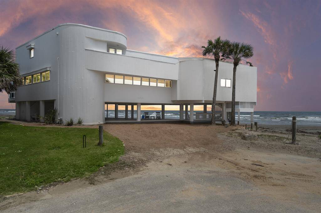 Situated on a quiet cul de sac, This modern, one of a kind beachfront home offers dramatic panoramic ocean views from every angle. The home features a sleek rounded architectural design, loaded with windows throughout.