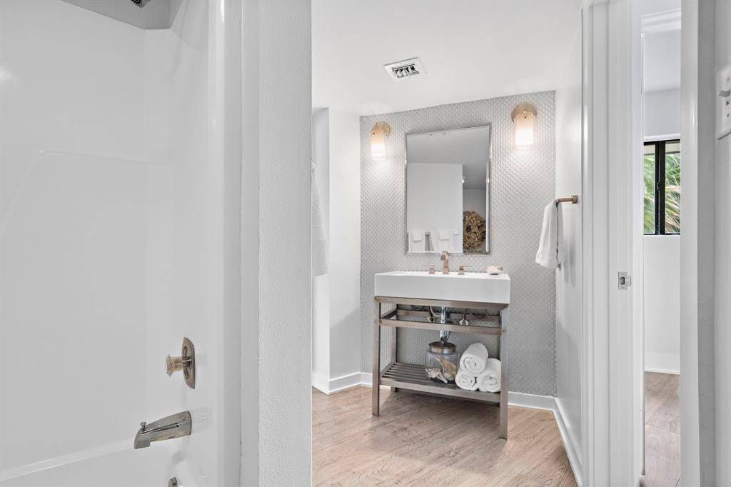 Second level full bathroom is down a short hallway from the living area.