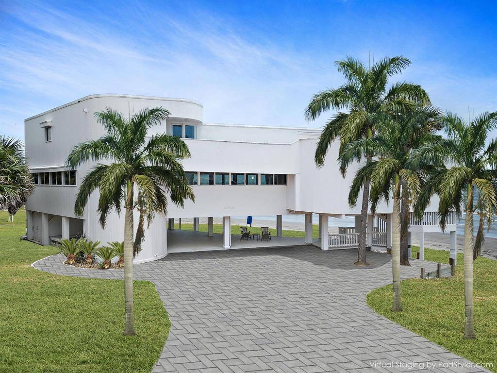 Virtually staged stamped concrete and landscaping show the endless possibilities for this beachfront palace.