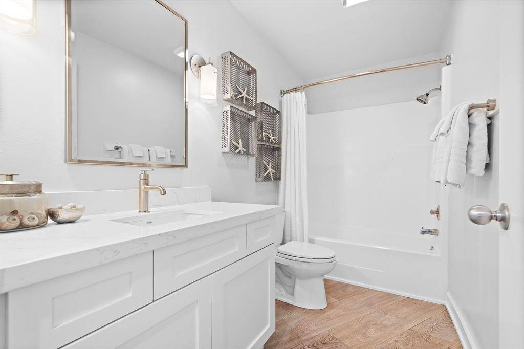 Shared second floor bathroom has fine marble countertops and plenty of storage.
