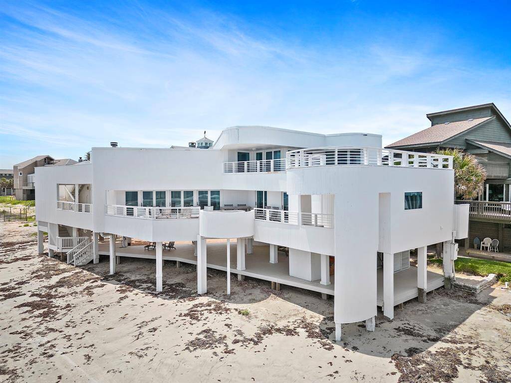 This modern, one of a kind, two-story beachfront home offers dramatic panoramic ocean views from every angle. The home features a sleek rounded architectural design, loaded with windows throughout.