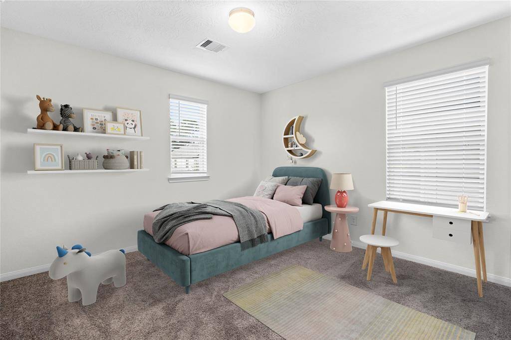 This secondary bedroom features high ceilings, custom paint, plush carpet, and large windows with privacy blinds!