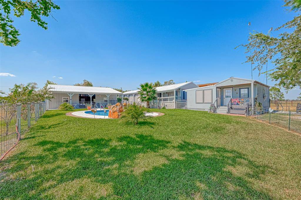 3 bed 2 bath mobile home, rental with 20x30 barn and pool. Shares yard with grey bunkhouse.