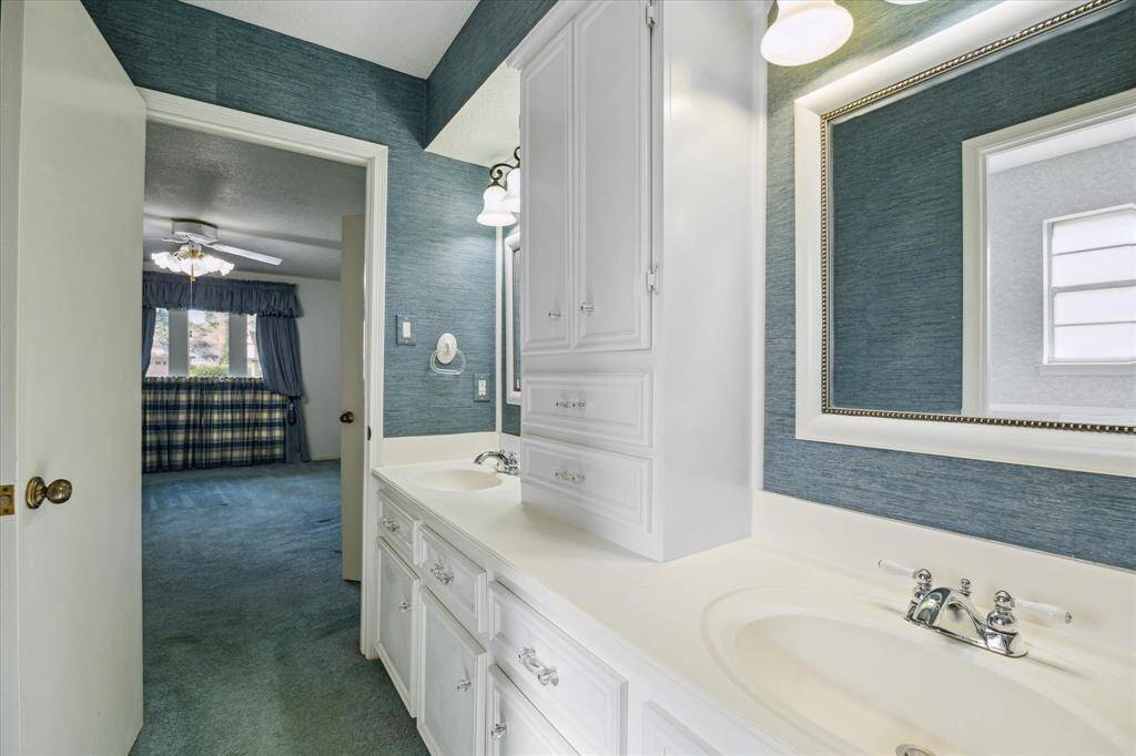 The ensuite bathroom has a walk-in shower, complete with comfortable bench seating.
