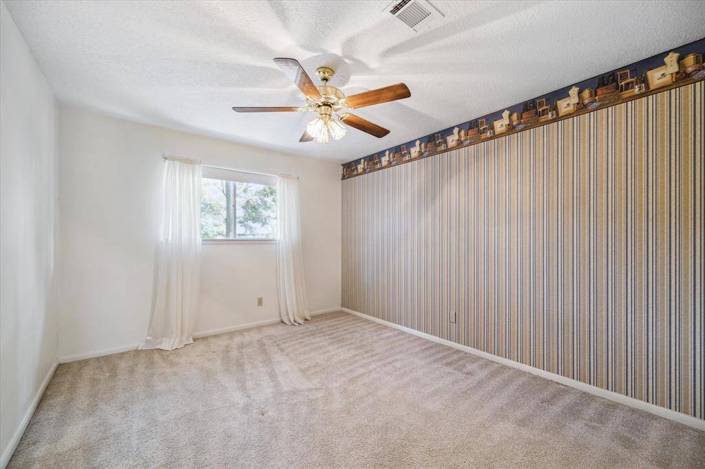 Inviting upper-level bedroom featuring a walk-in closet.