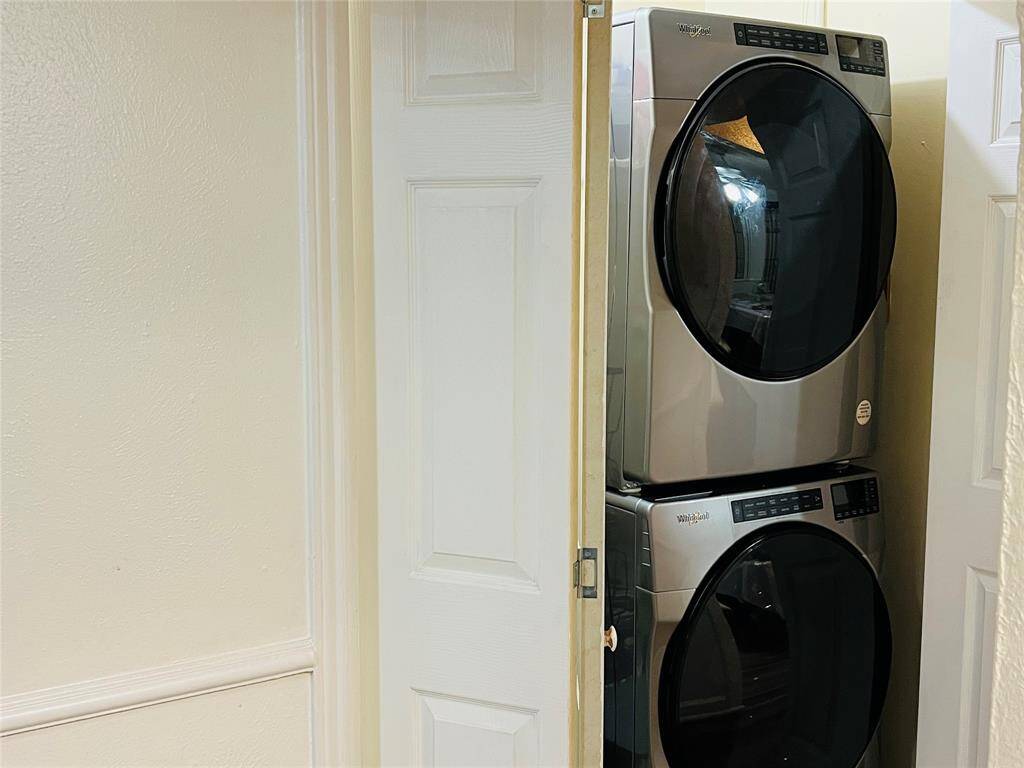 Separate laundry area with front load washer dryer
