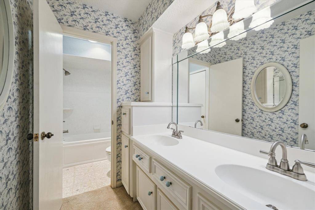 Enjoy the convenience of a dual-sink vanity and a combined tub/shower in the upstairs bathroom.