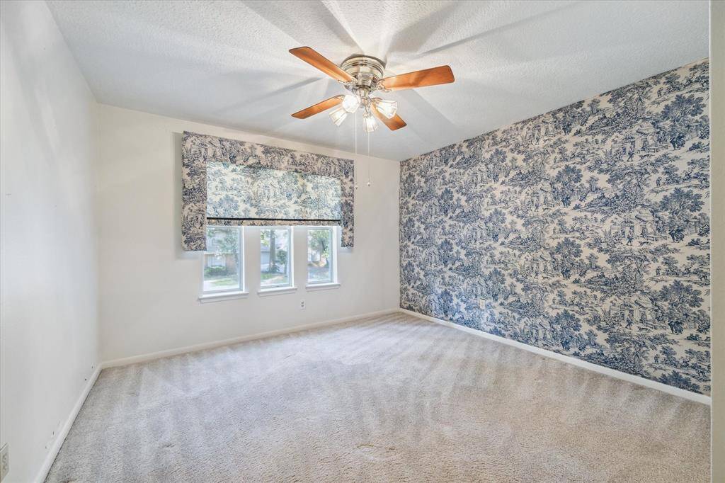 Inviting upper-level bedroom featuring a walk-in closet.