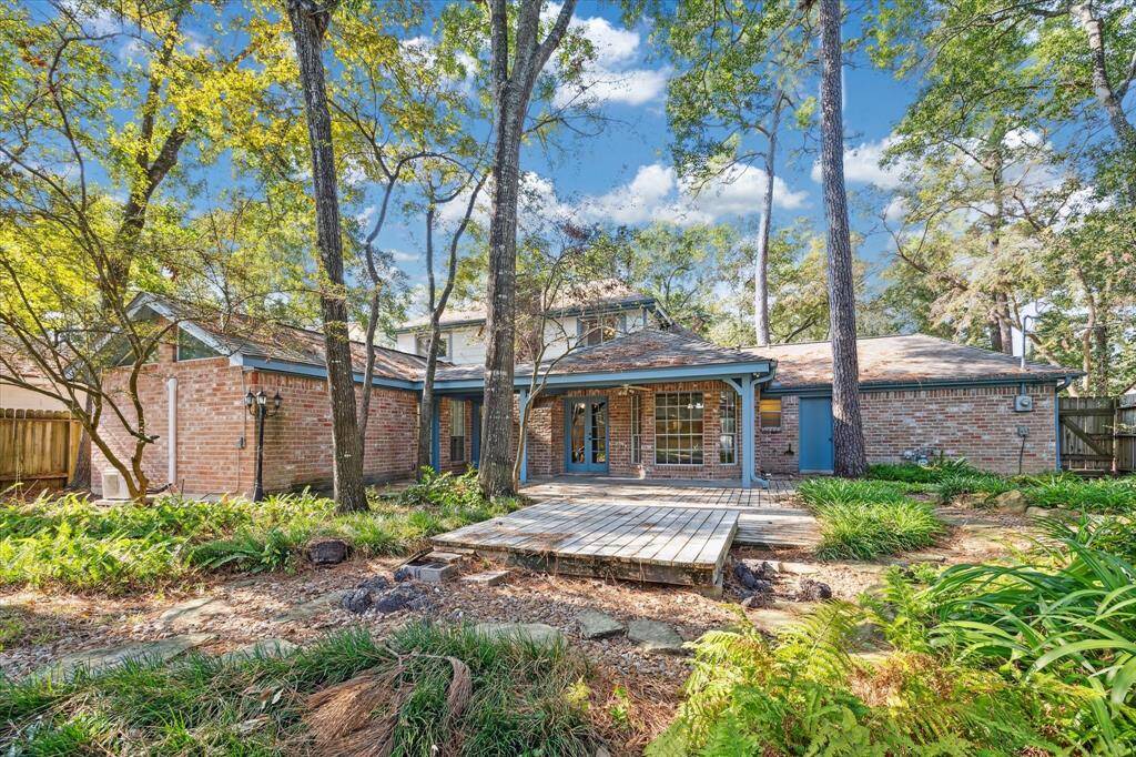 Expansive, tree-lined backyard with convenient storage shed.