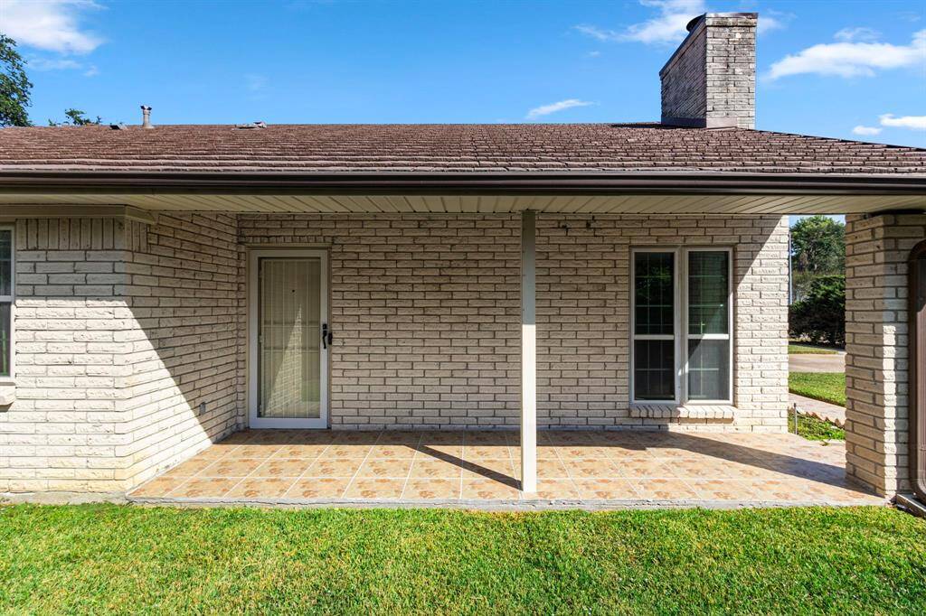 Covered porch along the side of the home welcomes guests in style.