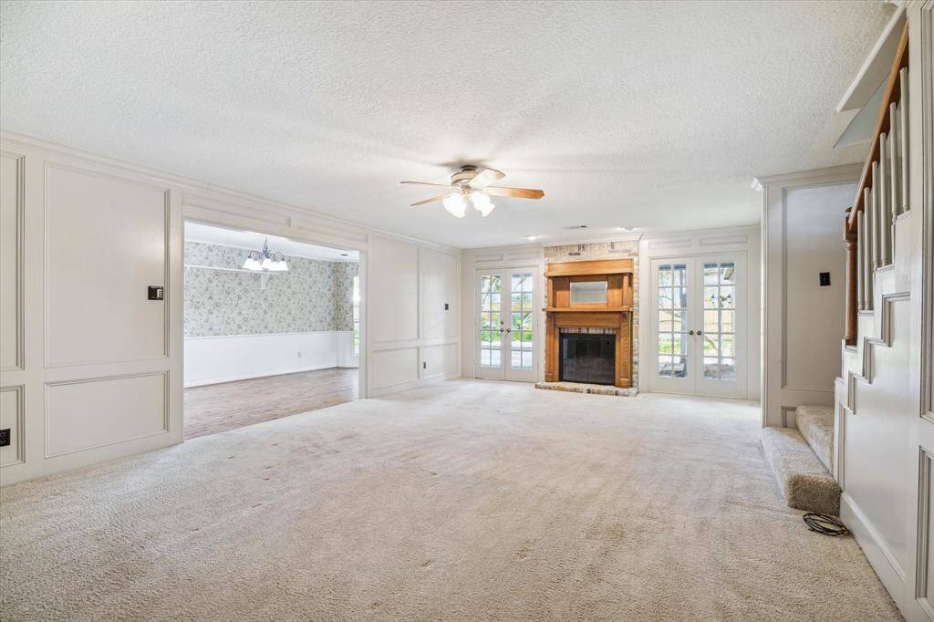 Enjoy the cozy ambiance of a gas fireplace in your living space, complete with elegant French doors that open to a serene backyard.