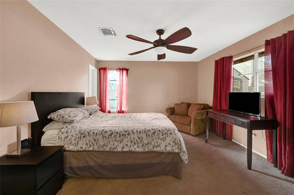 Primary bedroom with large window and private full bathroom.