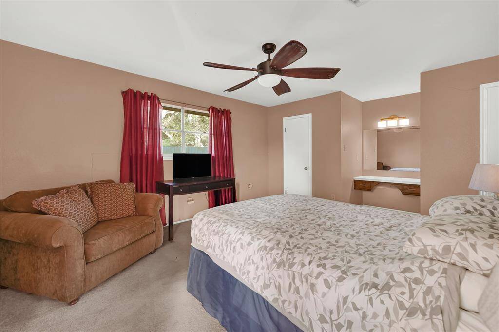 This is a cozy, well-lit bedroom featuring a built-in vanity area.