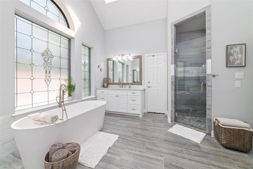 Another view of this stunning primary bathroom showcasing the recent updates, including the separate shower. It's the perfect spot to relax after a long day.