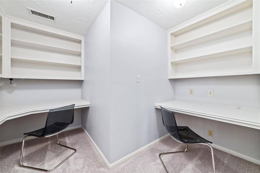 Versatile room behind the office has ample storage and could be used for homework stations, a craft/art room, storage, closet, etc.
