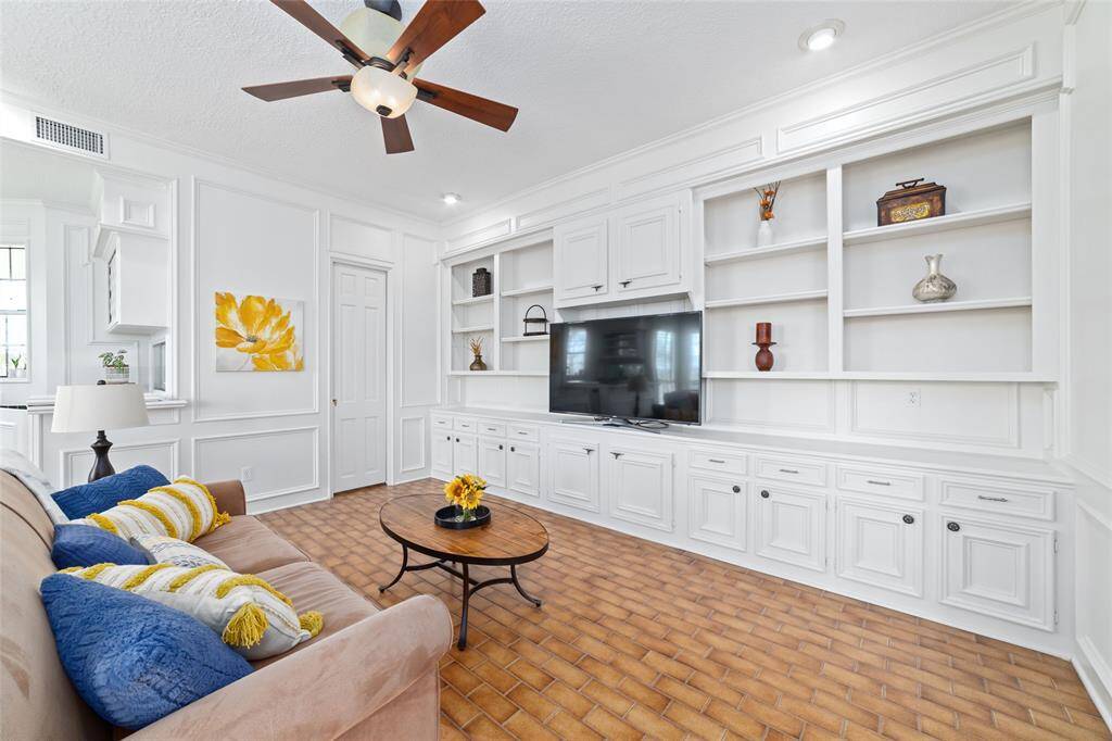Step into this bright and spacious family room, where a cozy fireplace invites you to relax and unwind on chilly winter days. Stunning double glass doors lead to your private backyard oasis.