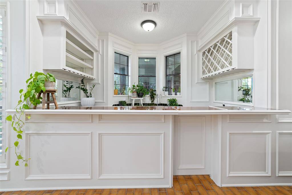 Another view of the versatile family room with wall-to-wall cabinetry and shelving and a conveniently located 1/2 bath.