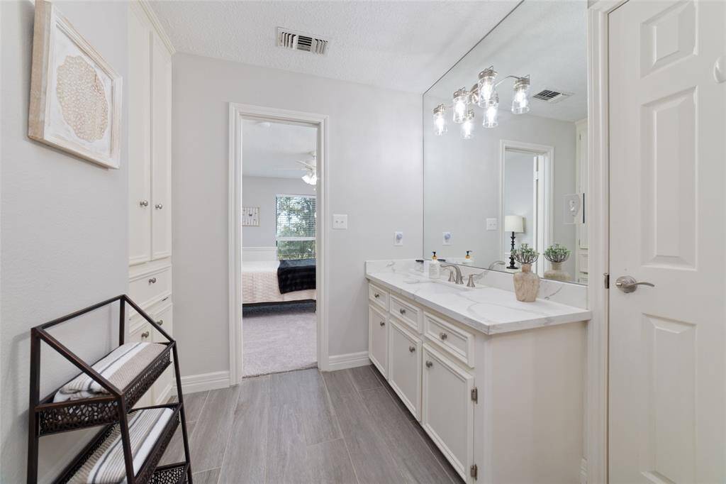Family Room wet bar area boasts a charming bay window, brick flooring, flip top counter for easy accessibility, built-in wine rack, cabinets and shelving. A perfect balance of functionality and style.