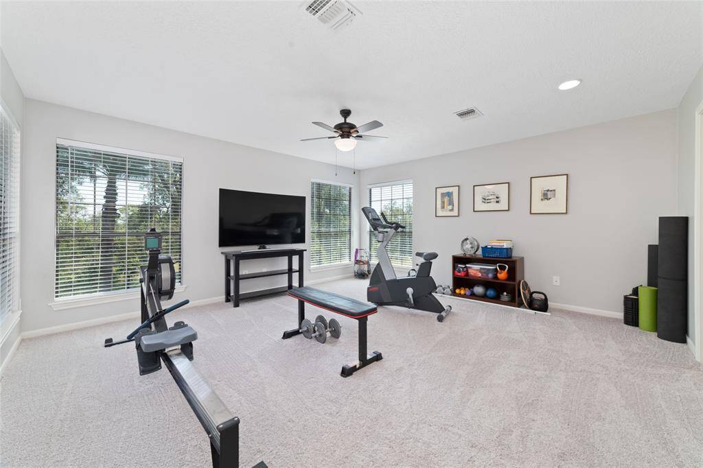 Upstairs en-suite bathroom has been recently updated and features a spacious walk-in shower with decorative tile accents, large vanity with quartz counters, linen closet and beautiful wood looking tile flooring. It has a clean, crisp design with neutral tones.
