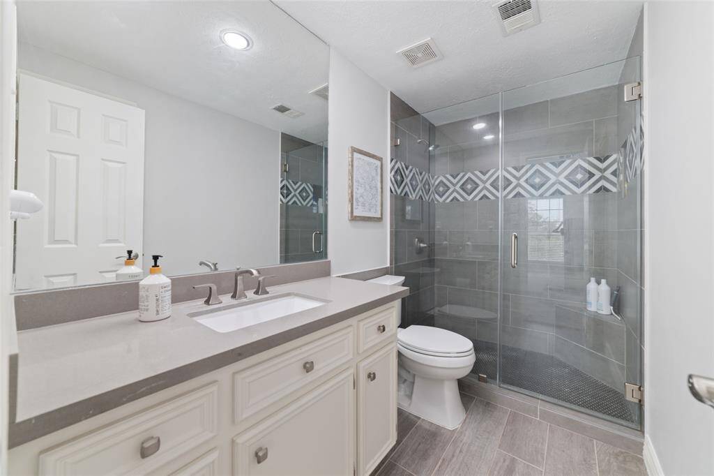 Upstairs bedroom features beautiful wainscoting wall trim and recent paint and carpet. Large picture window overlooks the backyard paradise.