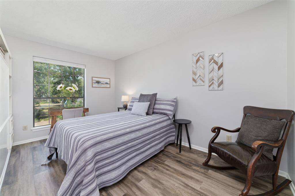 Garage Apartment kitchen features luxury vinyl plank flooring, beautiful counters and backsplash, tons of cabinet space, new stainless steel refrigerator, electric range and microwave.