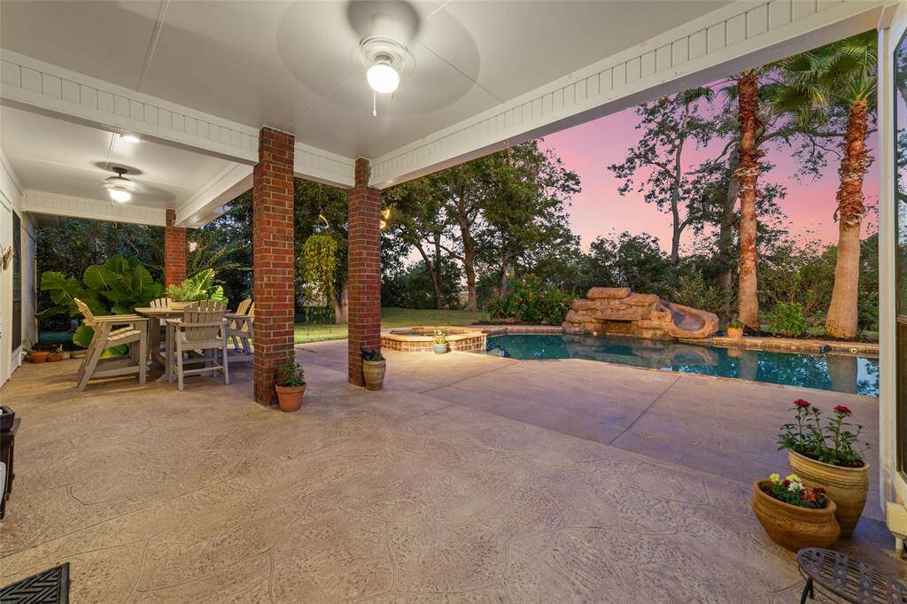 Welcome to your own backyard oasis featuring a luxurious in-ground pool with an attached spa, surrounded by lush landscaping, mature trees and the tranquil sounds of nature.