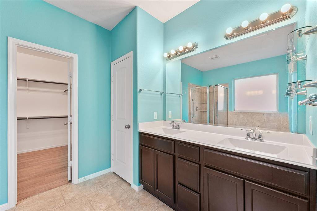 Primary bathroom with double sinks - walk-in closet
