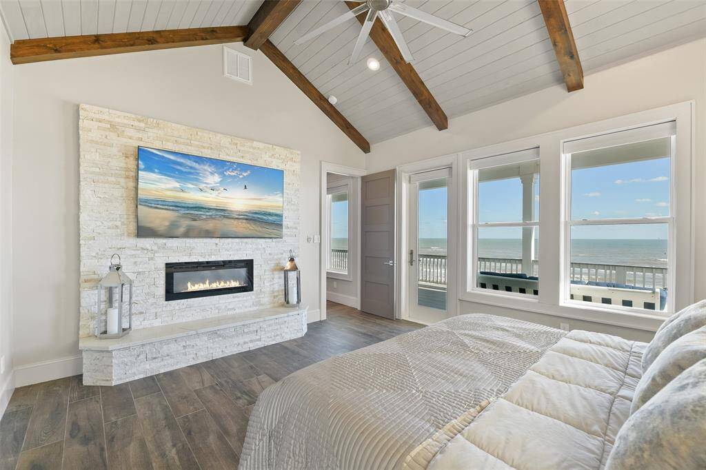 The primary bedroom features a custom gas fireplace with exquisite stonework, providing warmth and elegance. Enjoy incredible views of the Gulf right from the comfort of your luxurious retreat.