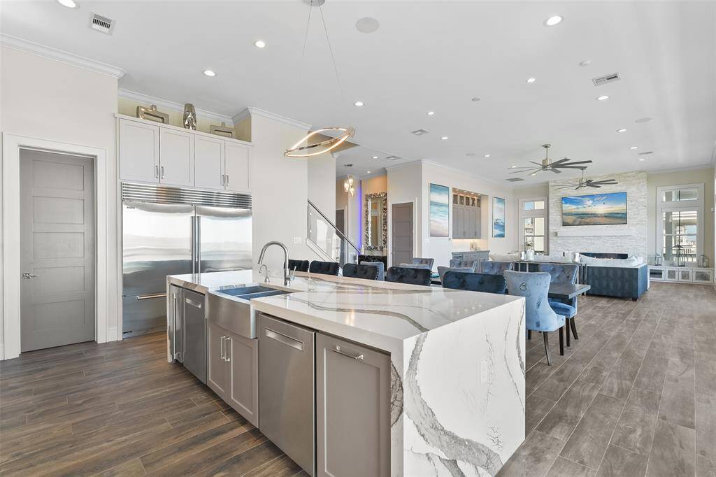 A chef's dream come true! This luxury kitchen features a high-end appliance package, including two Sub-Zero refrigerators and a 60" dual-fuel Wolf range. Every detail is designed for gourmet perfection.