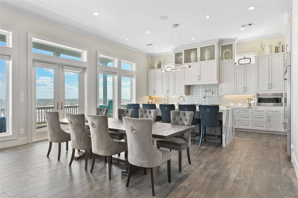 The dining area, perfectly situated between the kitchen and living spaces at the heart of the main floor, offers ample room for entertaining any size party of guests. With its open layout and elegant design, this home ensures every gathering is both comfortable and memorable.
