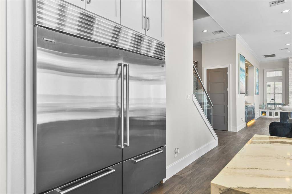 This luxury kitchen features a state-of-the-art Sub-Zero refrigerator, offering unmatched performance and sleek design. It also features not 1 but 2 pantries, including a lockable owner's pantry for those who may consider exploring the short-term rental opportunities of this property.