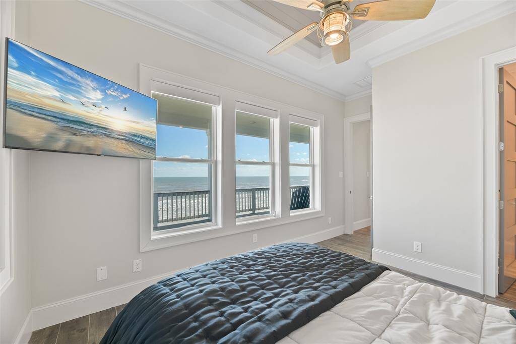 This bedroom offers stunning views of the beach, allowing you to wake up to the beauty of the ocean every day. It's the perfect blend of comfort and coastal charm.