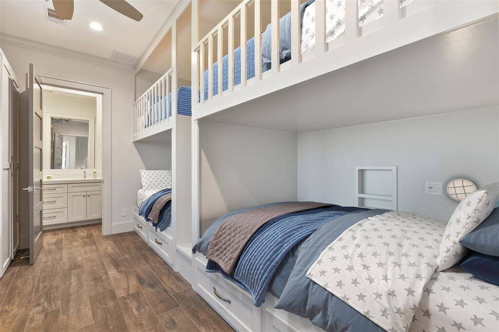 This spacious bunk room features four custom-built bunk beds, offering a perfect blend of style and functionality. Complete with an ensuite bathroom, this room provides both comfort and privacy, making it an ideal space for family or guests in this luxurious beachfront home.