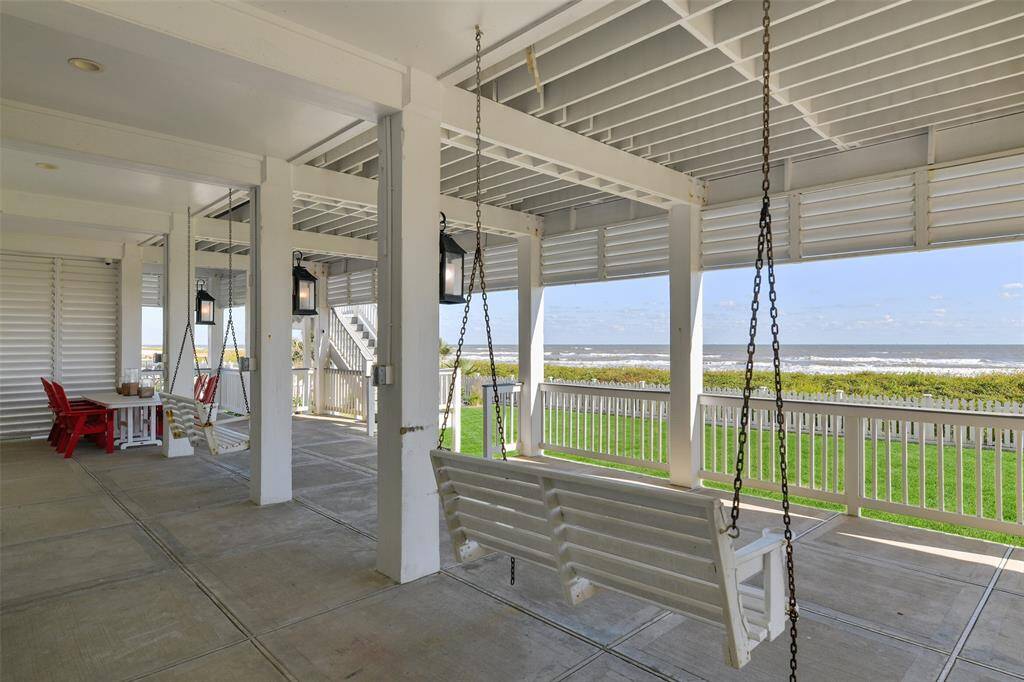The ground floor patio is the perfect spot to relax, featuring two Gulf-facing swings, custom lighting, and outdoor dining furniture. The white picket fully fenced backyard around the property with unique decorative insert, includes a separate dog run and upgraded landscaping, creating a beautiful and functional outdoor oasis.