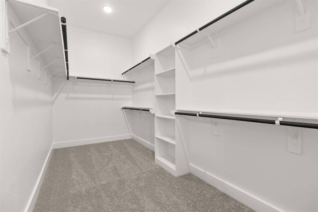 Beyond the bathroom, a generous walk-in closet offers more than enough space to keep your