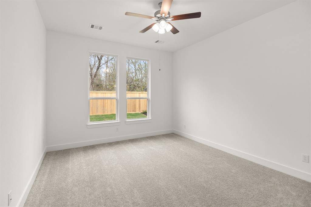 As you step into the primary bedroom, you’re immediately greeted by a tranquil and spaciou