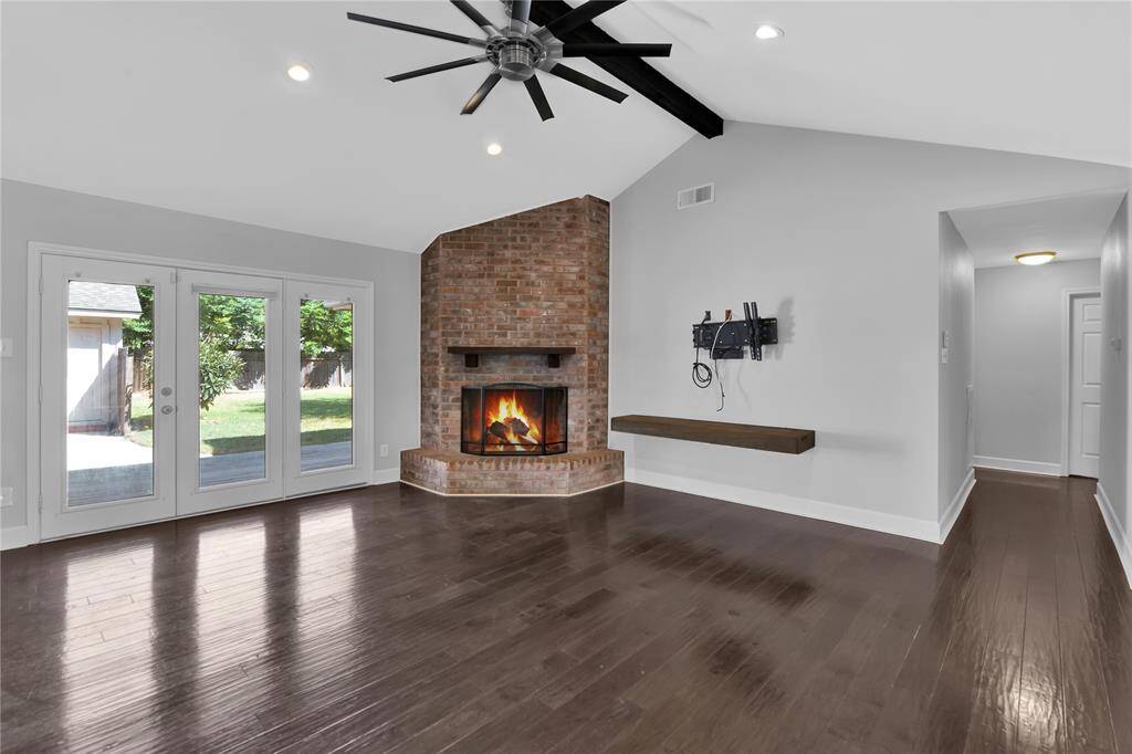 Inviting Family Room with Cozy Fireplace (Virtually Lit) and Abundant Natural Light