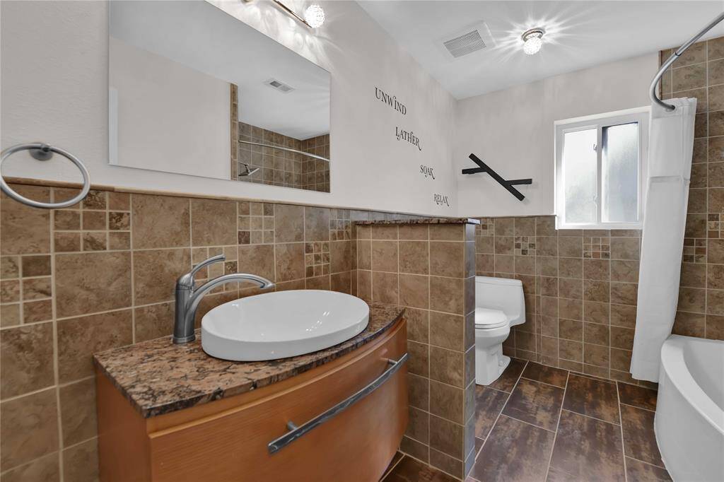Chic Guest Bath with Floating Vanity and Designer Finishes