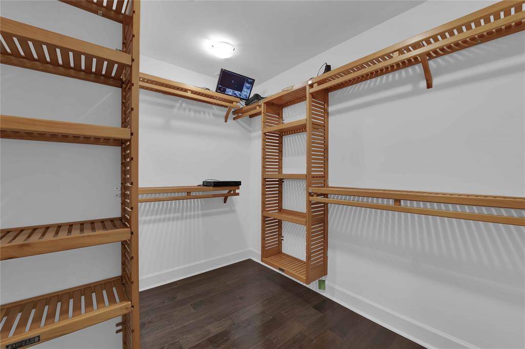 Experience organized luxury in the spacious walk-in closet, complete with custom shelving, an full-length mirror, and a security system included with your new home.