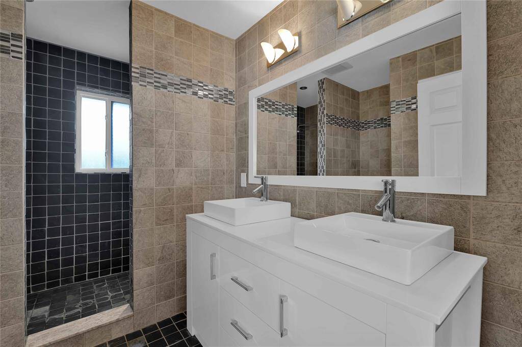 Experience modern luxury with the updated primary bath, featuring dual vanities and a spacious double shower.