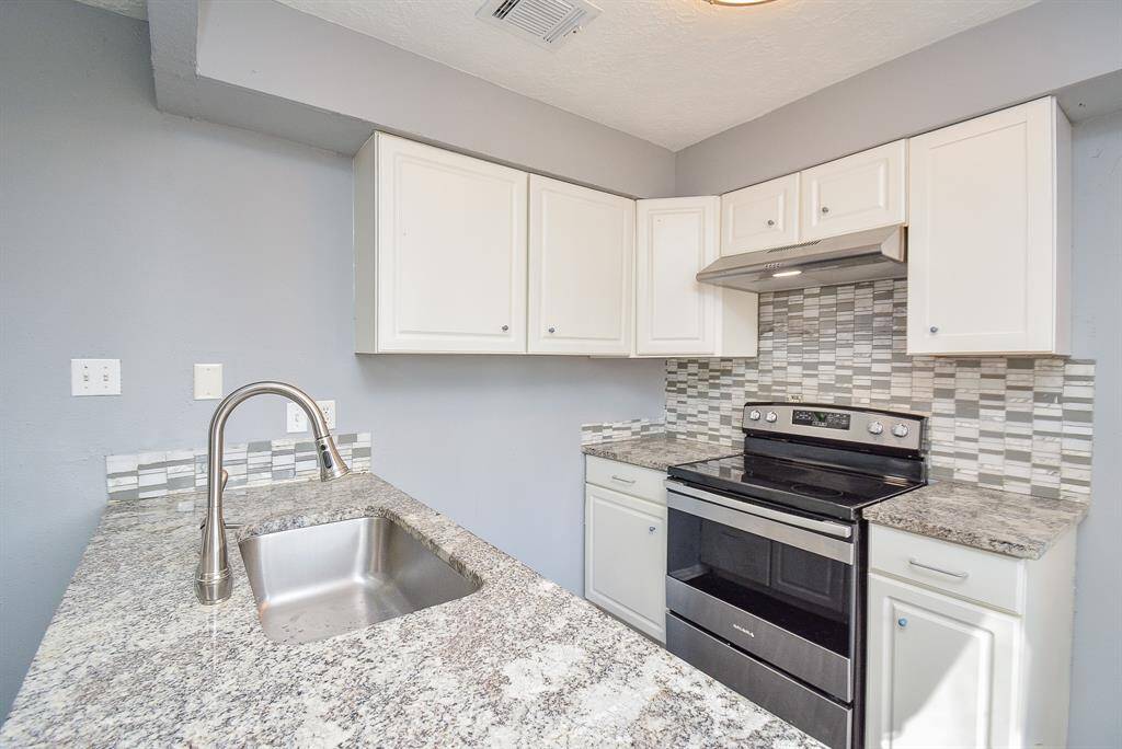 Gorgeous Kitchen with Granite Countertops and Updated Backsplash
