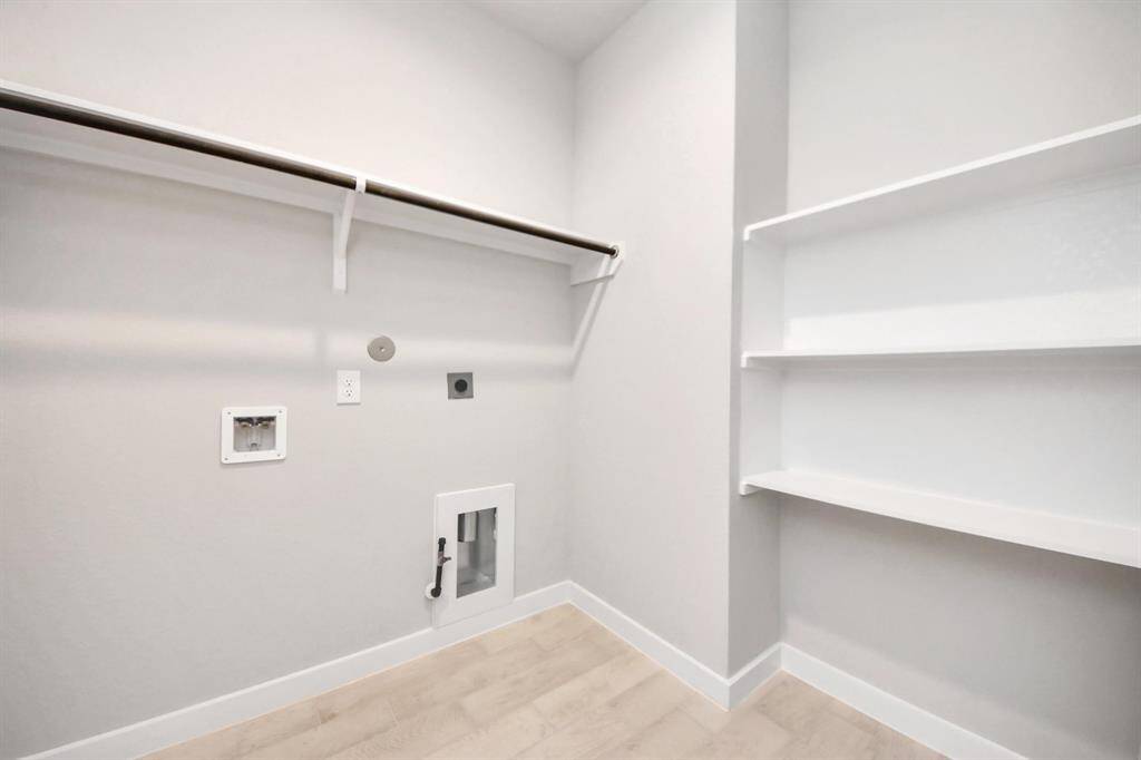 A perfect blend of functionality and comfort. Capture the essence of easy living with a first-floor laundry room, thoughtfully equipped with shelving for effortless organization. Both electric and gas connections available.