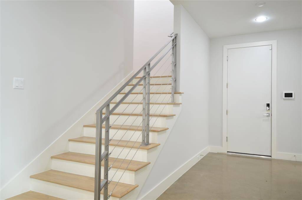 Stairs to the second floor from first floor foyer with two bedrooms.