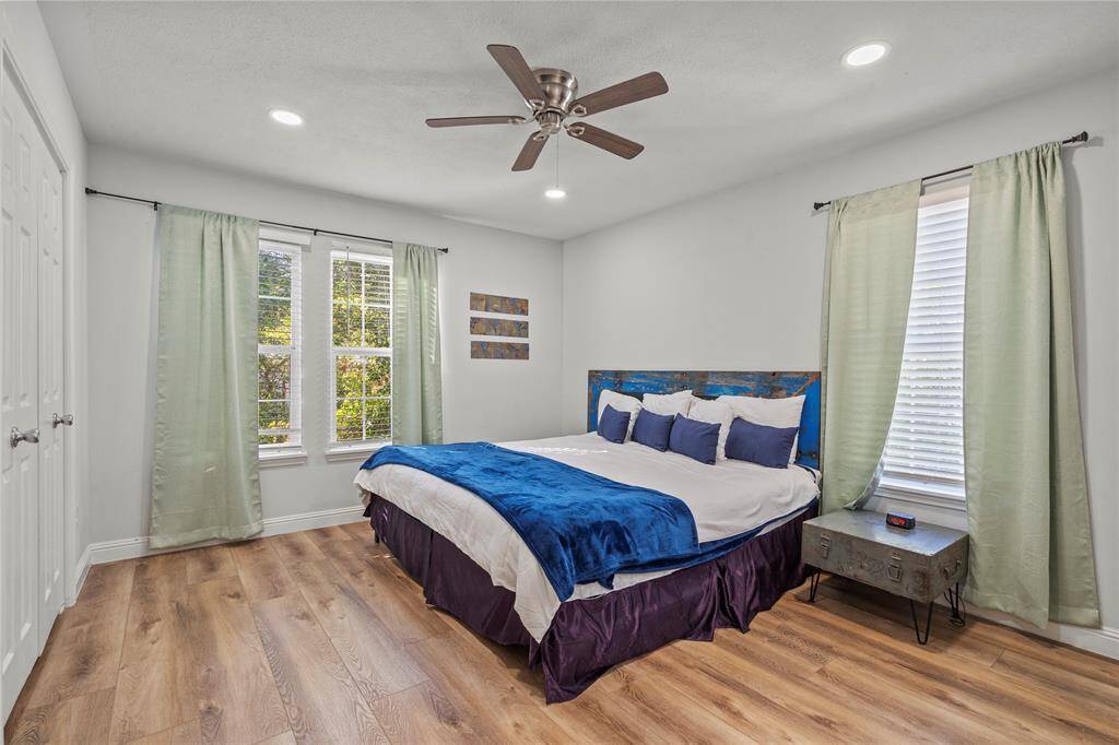 Discover the charm of this sunlit secondary bedroom, boasting soaring windows, newly updated finishes, and sleek hardware. Ideal for hosting guests or providing a cozy retreat for family members.