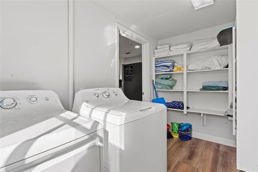 Bask in the natural light of this serene bedroom, boasting high ceilings, large windows, and modern updates including new flooring and sleek fixtures.