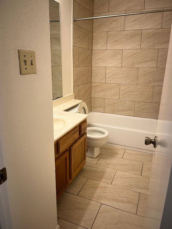 Secondary bath that has tiled flooring and tiled around  tub